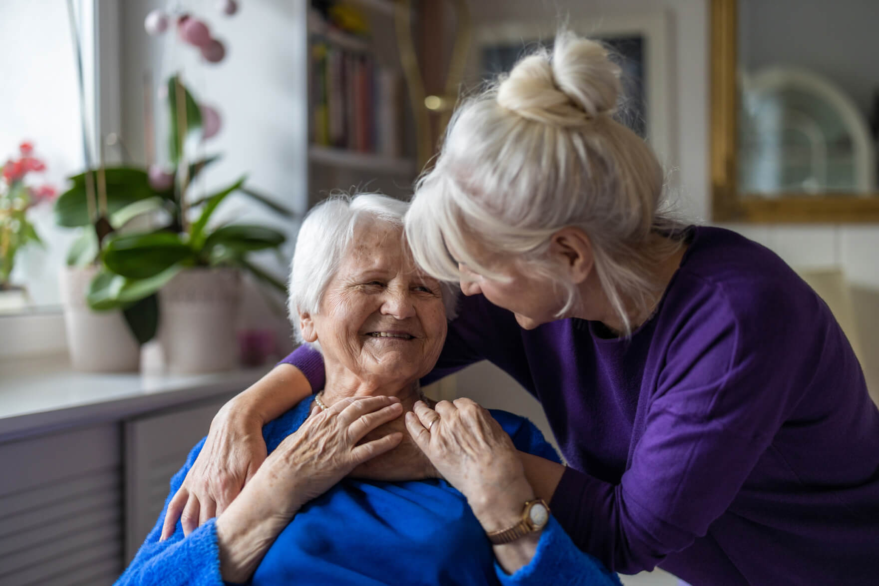 Woman hugging her senior mother